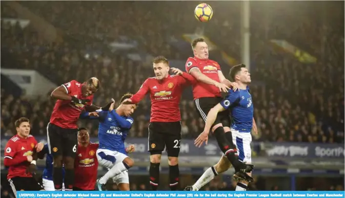  ??  ?? LIVERPOOL: Everton’s English defender Michael Keane (R) and Manchester United’s English defender Phil Jones (2R) vie for the ball during the English Premier League football match between Everton and Manchester United at Goodison Park in Liverpool. — AFP