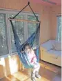  ??  ?? Natasha, 10, shows off her bright new bedroom, left. She chose the colours and designs herself. She relaxes in the tree house, right. She and her sister helped stain the floorboard­s.