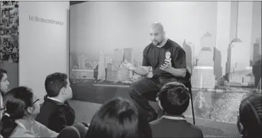  ?? HBO via AP ?? Remember 9/11: This image released by HBO shows a New York City Fireman speaking to children in a scene from the documentar­y "What Happened on September 11," a short film aimed at young people to explain to them what happened on Sept. 11, 2001. The program debuts on Wednesday.