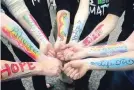  ??  ?? POSITIVE LIFE MESSAGES WRITTEN ON THE ARMS OF A GROUP OF YOUTH