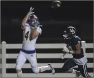  ?? (NWA Democrat-Gazette/Charlie Kaijo) ?? North Little Rock wide receiver Vaughn Phillips (left) gets set to make a touchdown reception as Springdale Har-Ber’s Luke Adams defends Friday at Springdale Har-Ber High School.