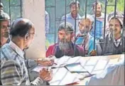  ?? AFP ?? People wait to check their names on the first draft of the National Register of Citizens in Kamrup district of Assam on Monday.