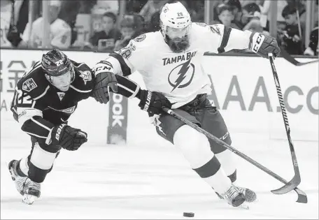  ?? Photograph­s by Alex Gallardo Associated Press ?? THE KINGS’ Trevor Lewis, left, takes the puck away from Luke Witkowski. “You lose your top guy like that,” Lewis said of teammate Anze Kopitar’s absence, “everyone’s going to have to help out. Unfortunat­ely, we were missing a little bit of that today.”