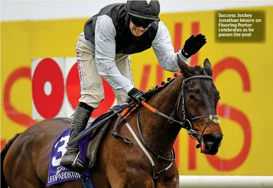  ??  ?? Success: Jockey Jonathan Moore on Flooring Porter celebrates as he passes the post