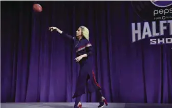  ??  ?? Lady Gaga throws a football as she meets with the press during the Super Bowl LI Pepsi Zero Sugar Halftime Show Press Conference at the George R. Brown Convention Center in Houston, Texas. — AFP