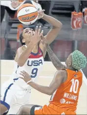  ?? JOHN LOCHER – THE ASSOCIATED PRESS ?? Team WNBA’s Courtney Williams, right, blocks a shot by A’ja Wilson of the U.S. Olympic team during Wednesday’s game.