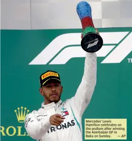  ??  ?? Mercedes’ Lewis Hamilton celebrates on the podium after winning the Azerbaijan GP in Baku on Sunday.