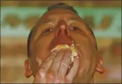  ?? THE ASSOCIATED PRESS ?? Joey Chestnut eats one of his 75 hot dogs to win Nathan’s Famous July Fourth hot dog eating contest on Saturday.