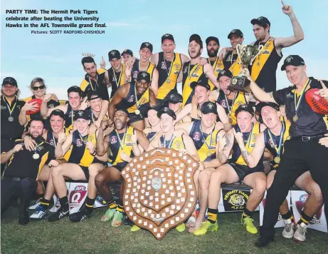  ?? Pictures: SCOTT RADFORD- CHISHOLM ?? PARTY TIME: The Hermit Park Tigers celebrate after beating the University Hawks in the AFL Townsville grand final.