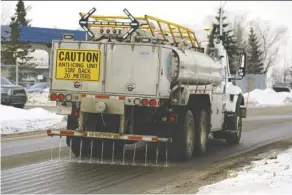  ?? LARRY WONG ?? A City of Edmonton truck applies a calcium chloride anti-icing solution to the road in February 2018.