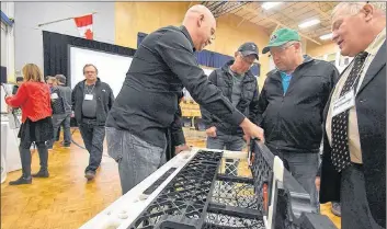  ?? TINA COMEAU ?? Scott Dauphine of the Lobster Trap Company explains features of their plastic lobster trap at a business innovation event at NSCC Burridge.