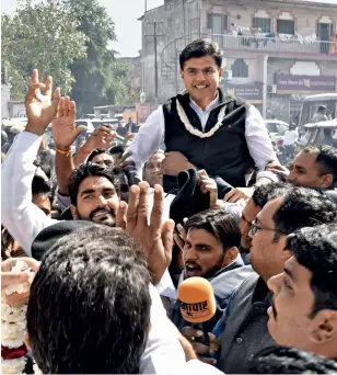  ??  ?? TURNAROUND Congress supporters with Sachin Pilot after the bypoll wins in February