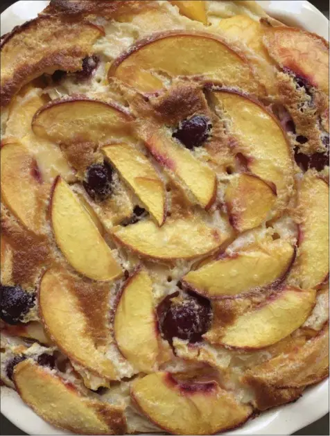  ?? ELIZABETH KARMEL VIA AP ?? The recipe for clafoutis can be tailored to whatever summer fruit is on hand, and not just cherries, which are traditiona­lly used in France for this rustic dessert that envelopes the fruit in a custardy crepe-like batter.