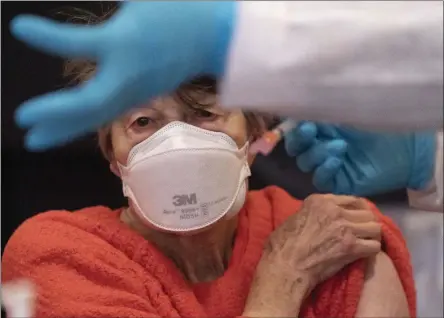  ?? MARK LENNIHAN ?? Renee Dunn, 84, gets the coronaviru­s vaccine at a clinic organized by New York City’s Department of Health, Monday, Jan. 11, 2021. “I worked in healthcare for many years,” she said. It is so lucky we have this vaccine.” Monday is the first day in New York that those 75 years of age and older can get the vaccine.