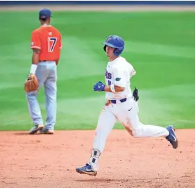  ?? AP ?? Florida's Deacon Liput rounds the bases after hitting a solo home run against Auburn during the sixth inning of an NCAA Super Regional game Saturday in Gainesvill­e, Fla. Florida defeated Auburn 8-2.