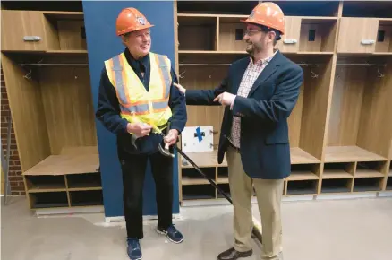  ?? RICK KINTZEL/THE MORNING CALL ?? Phillies Hall of Fame pitcher Steve Carlton, left, speaks with IronPigs General Manager Kurt Landes in the IronPigs locker room Thursday during a tour of the team’s expansion and renovation of the clubhouse area at Coca-Cola Park in Allentown.