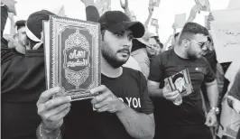  ?? AMEER AL-MOHAMMEDAW­I USA TODAY NETWORK ?? Supporters of the Popular Mobilizati­on Forces protest in Tahrir Square in Baghdad to denounce the burning of Islam’s holy book the Quran and the Iraqi flag in Stockholm.