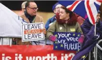  ?? - AFP file photo ?? PROTEST: A pro-Brexit protester, left, interacts with a supporter of a second EU referendum, right, outside the Houses of Parliament in central London.