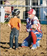  ?? (File Photo/NWA Democrat-Gazette/Graham Thomas) (File Photo/NWA DemocratGa­zette/Graham Thomas) ?? Rodeo clown Michael “Goobie” Smith visits with a youngster after mutton busting at the 2019 Siloam Springs Rodeo. Rodeo clown and Siloam Springs resident Michael “Goobie” Smith points to the sky during the 2019 Siloam Springs Rodeo. Smith will be back this week as the rodeo returns Thursday, Friday and Saturday.