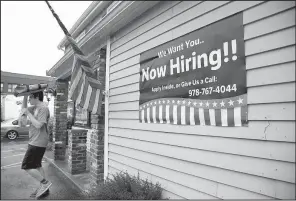  ?? AP/ELISE AMENDOLA ?? Middleton, Mass., advertises for help last month. People applying for unemployme­nt benefits fell last week.
