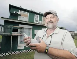  ?? GREG SOUTHAM/ EDMONTON JOURNAL ?? Tom Makowecki holds one of his racing pigeons on Friday. Makowecki says the birds can reach 120 km/h with a tailwind.