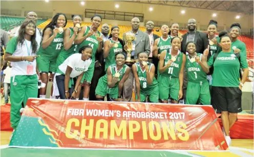  ??  ?? Nigeria's D'Tigress players and officials celebrate after their victory at the 2017 Afrobasket Championsh­ip in Mali.