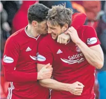  ??  ?? Level best: Ash Taylor, right, celebrates with Scott McKenna