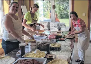  ?? SUBMITTED PHOTO/INVERNESS COUNTY CARES ?? Volunteers, left to right, Karen Wager, Patsy Wayling and Bonnie Boulton prep pizzas at last year’s Inverness County Cares annual pizza sale.