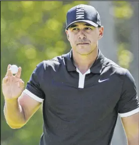  ?? Seth Wenig The Associated Press ?? Even-keel Brooks Koepka finishes putting on No. 2 during the third round of the PGA Championsh­ip on Saturday at Bethpage Black in Old Bethpage, N.Y. Koepka holds a commanding sevenshot lead entering Sunday’s final round.