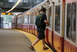  ?? HERALD STAFF FILE ?? A RARE PASSENGER: A rider boards a Red Line train at Ashmont Station on June 2.