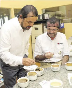  ??  ?? Head of Nestlé Anglo Dutch Caribbean Patricio Torres (left) and Nestlé Jamaica Country Manager Daniel Caron participat­ing in a cupping exercise at Stoneleigh Coffee Roasters factory.