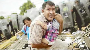  ?? REUTERS ?? The fearful look on the face of a Central American man cradling a baby in his arms as he scrambled away from a wall of Mexican police in riot gear quickly became one of the defining images taken by Reuters photograph­ers of the migrant caravan that started entering Mexico last month.