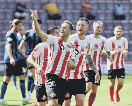  ??  ?? Aiden McGeady celebrates the first of his two goals at Tynecastle. Picture by Frank Reid