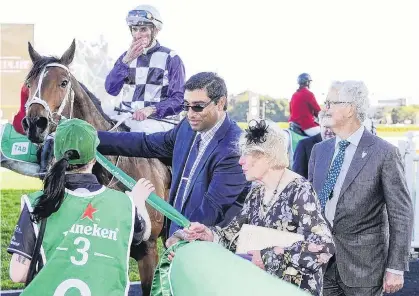  ?? PHOTO: BRADLEY PHOTOGRAPH­ERS ?? That was for Pat . . . Patrick Erin is led back to the winner’s enclosure by Jan Smith, widow of his breeder, the late Pat Smith, after winning the Metropolit­an Handicap at Randwick on Saturday.