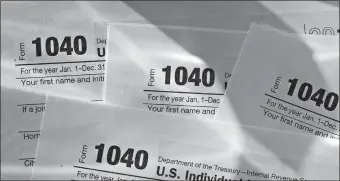  ?? DANIEL ACKER/BLOOMBERG ?? Internal Revenue Service 1040 Individual Income Tax forms for the 2017 tax year.