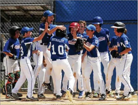  ?? STAN HUDY — SHUDY@DIGITALFIR­STMEDIA.COM ?? Saratoga Little League slugger Trevor Duthaler is greeted by his teammates after delivering a two-run home run in the second inning Sunday afternoon during the Section II playoffs at West Side Rec.