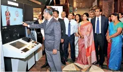  ??  ?? Nanda Fernando, Managing Director, Sampath Bank PLC, performing the first transactio­n on the humanoid teller banking robot at the Sampath Bank Headquarte­rs Branch in the presence of the members of the Bank’s Corporate Management