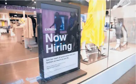  ?? JUAN FIGUEROA/THE DALLAS MORNING NEWS ?? A hiring sign at Express at a shopping mall in May in Dallas.