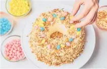  ?? JOE LINGEMAN/THEKITCHNC­OM ?? This easy Easter cake slathered in marshmallo­w icing is tasty and festive.