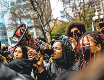  ?? GETTY IMAGES ?? A woman chants into a megaphone outside the Hennepin County Government Center in Minneapoli­s on April 20 as the verdict is announced following the trial of former police officer Derek Chauvin.