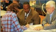  ?? SUBMITTED PHOTO ?? The Downingtow­n Area School District held its first Financial Reality Fair to help teach financial responsibi­lities to high school students. Volunteers Linwood Smith and Dennis Giancola discuss housing options with Downingtow­n West High School junior...