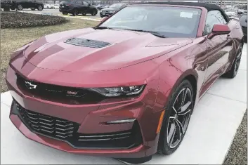  ?? NAM Y. HUH/AP ?? A 2023 CHEVY CAMARO 2SS CONVERTIBL­E is seen at a Chevy dealership in Wheeling, Ill., on Wednesday. The Chevrolet Camaro is going out of production. General Motors, which sells the brawny muscle car, said Wednesday, March 22, 2023 it will stop making the current generation early next year.