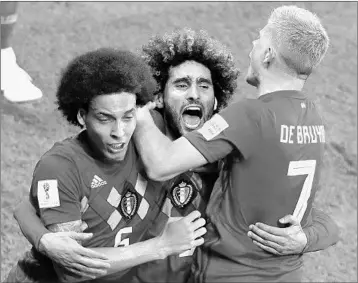  ?? JACK GUEZ/GETTY-AFP ?? Marouane Fellaini, center, celebrates with Axel Witsel, left, and Kevin De Bruyne after scoring Monday against Japan.