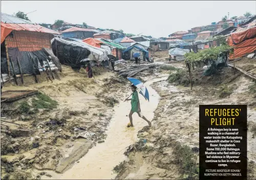  ??  ?? A Rohingya boy is seen walking in a channel of water inside the Kutupalong makeshift shelter in Coxs Bazar, Bangladesh. Some 700,000 Rohingya Muslims who fled militaryle­d violence in Myanmar continue to live in refugee camps.