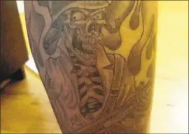  ?? A LOS ANGELES COUNTY ?? sheriff's deputy inked on his calf with a skull tattoo associated with the Compton station where he worked.