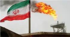  ?? RAHEB HOMAVANDI Reuters ?? | Bloomberg A GAS flare on an oil production platform in the Soroush oil fields alongside an Iranian flag in the Persian Gulf. |