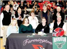  ?? MARK HUMPHREY ENTERPRISE-LEADER ?? Farmington senior Trey Waggle, seated with his parents, Josh and Kelley Waggle, and sister Paige Waggle, a Farmington freshman, signed a national letter of intent to play college football as a deep-snapper for Northeaste­rn University in Tahlequah,...