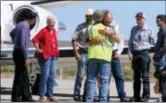  ?? BETH NAKAMURA — THE OREGONIAN VIA AP ?? Rancher Dwight Hammond Jr., center, is embraced after arriving by private jet at the Burns Municipal Airport, Wednesday in Burns, Ore. Hammond and his son Steven, convicted of intentiona­lly setting fires on public land in Oregon, were pardoned by...