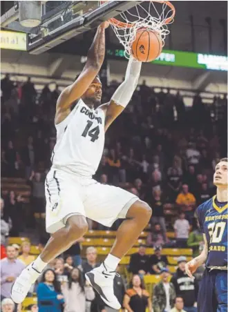  ?? Cliff Grassmick, Daily Camera ?? CU’s Tory Miller-Stewart dunks against UNC during Friday night’s season opener at the Coors Events Center in Boulder. He finished with 11 points and five rebounds.