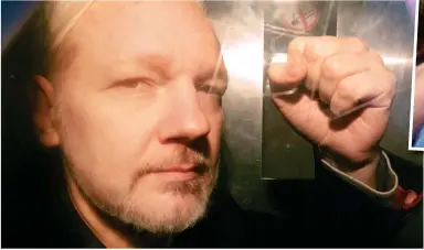  ??  ?? Defiance: Julian Assange raises a clenched fist as he arrives at court in a police van